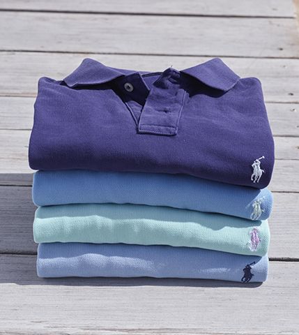 Neat stack of folded purple, blue & light green Polo shirts